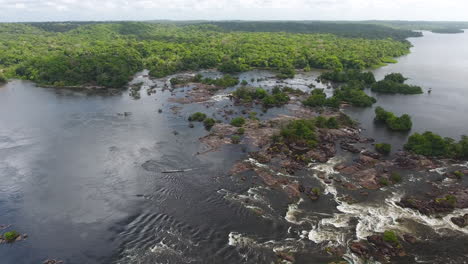 Motorised-canoe-going-up-rapids-in-saut-Maripa-French-Guiana-Brazil-Aerial-drone